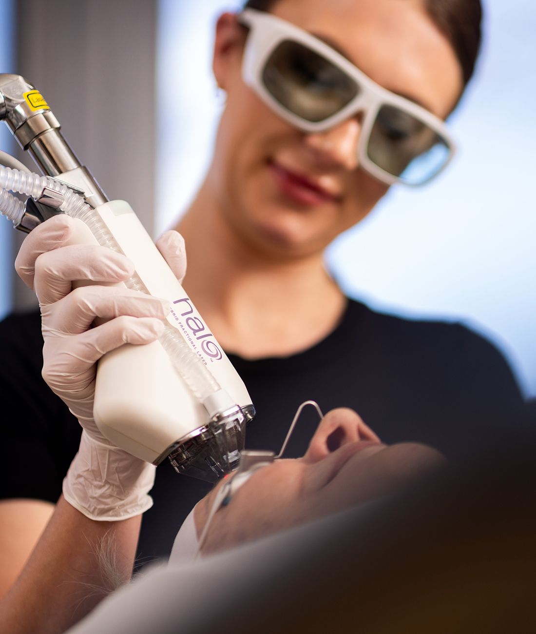Medical professional performing a laser treatment procedure.