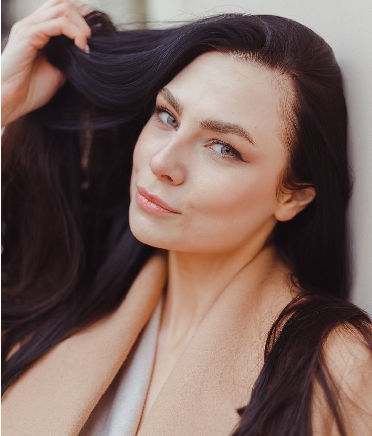 Woman with long dark hair and soft expression.