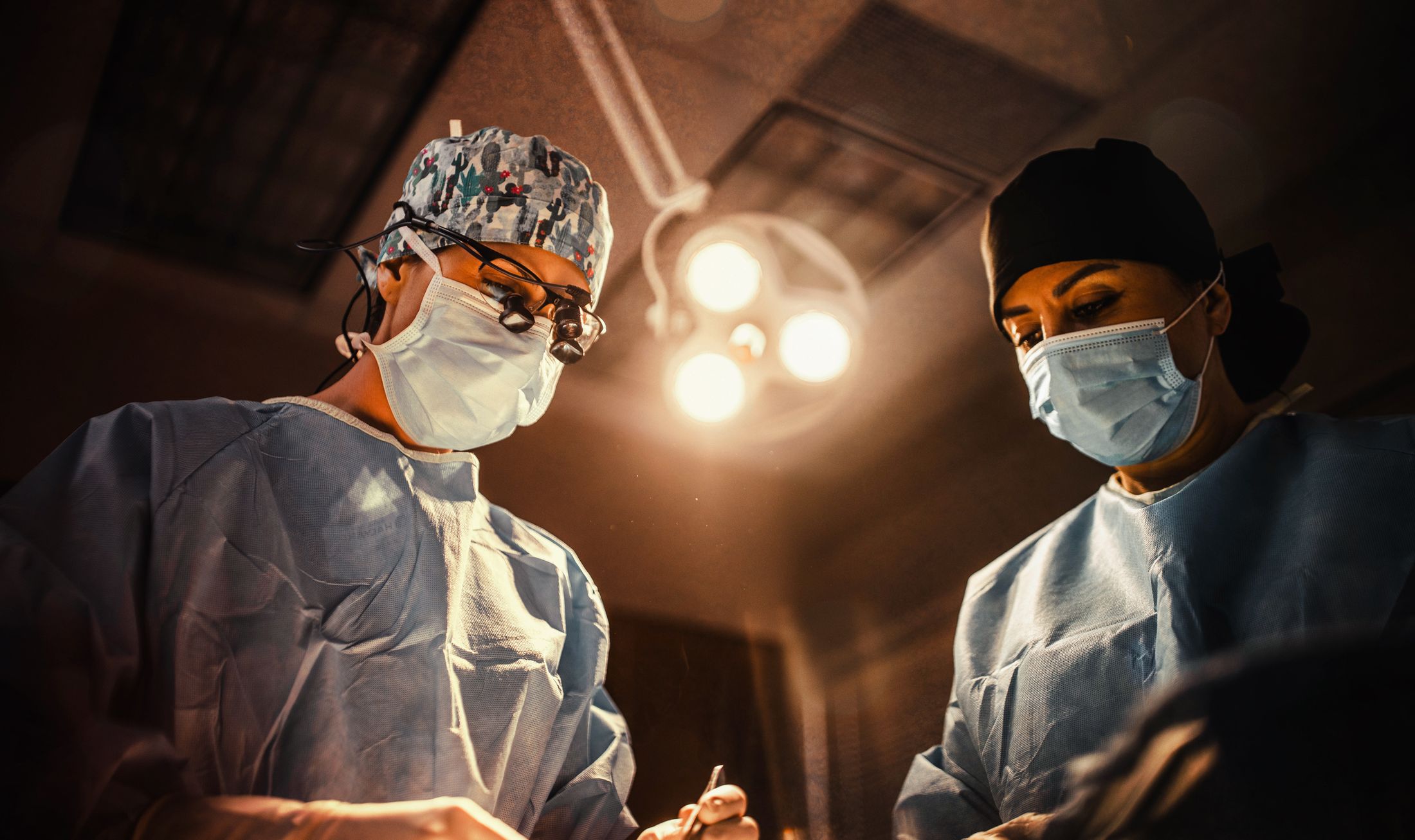 Surgeons performing a medical procedure in operating room.