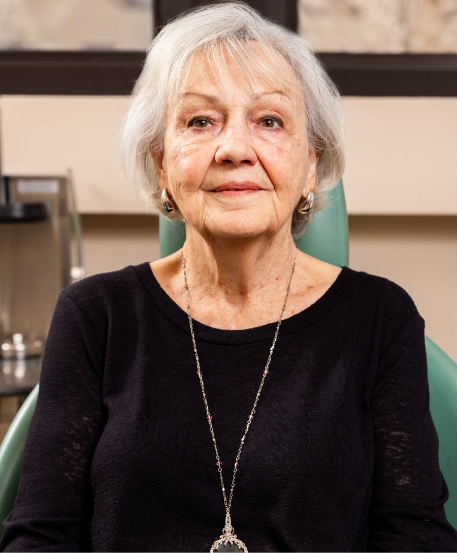 Portrait of an elderly woman in black sweater.