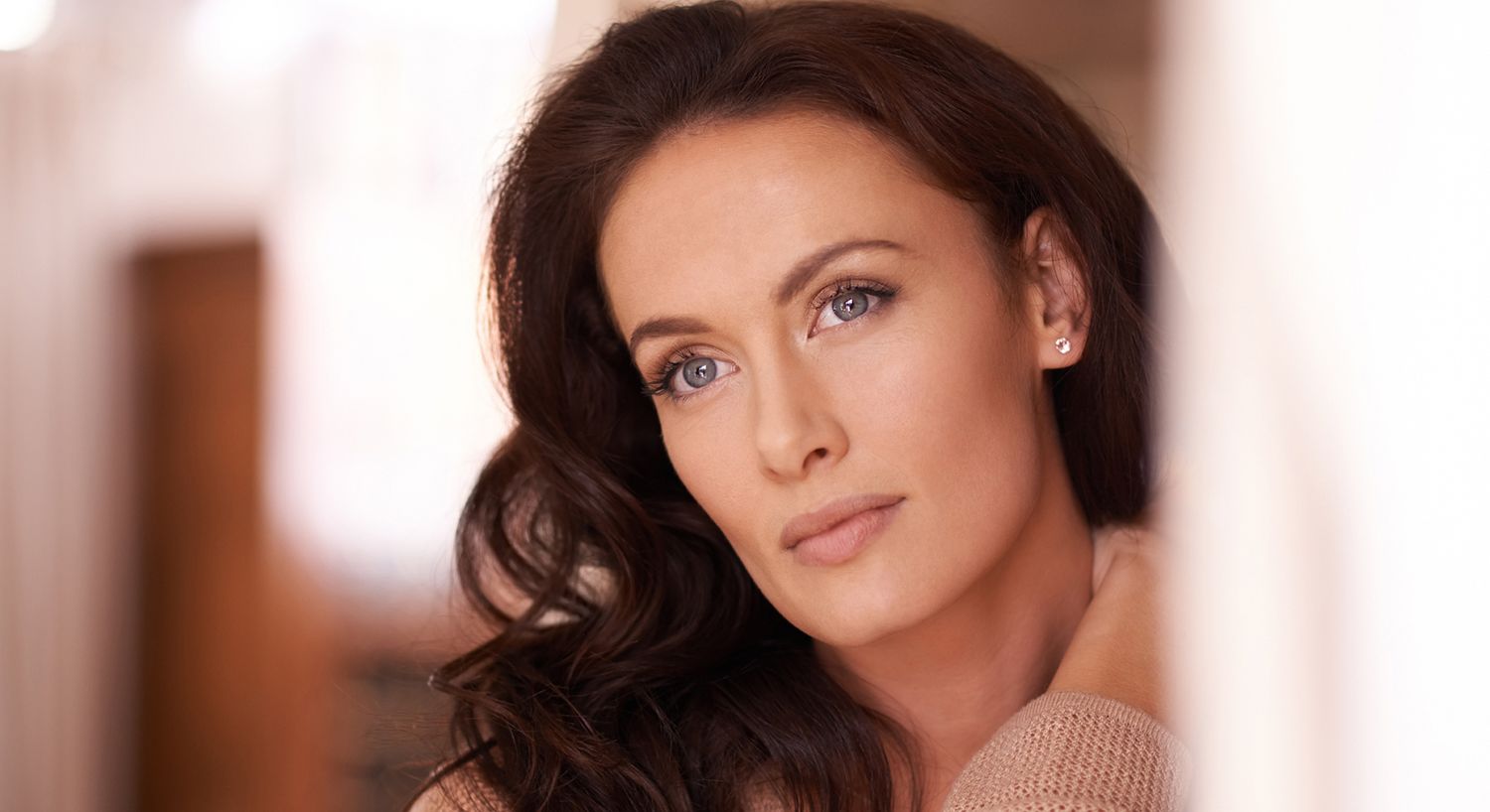 Smiling older woman resting chin on hand